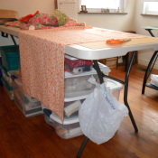 A sewing room garbage can by tying a bag to the table leg.