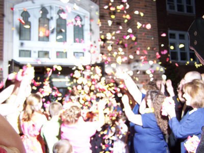 Flower petals being thrown at a wedding.