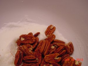 Add pecans to whipped egg whites.