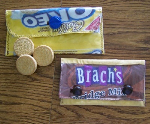 Two small pouches made from candy or cookie wrappers.