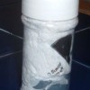 Plastic bags stored in a recycled plastic container.