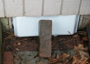 Makeshift Vent Hole Covers - Plastic bags and styrofoam with a brick holding it in place.