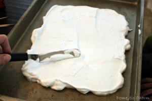 Spreading the shaving cream onto pan.