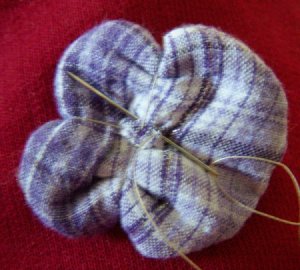 Sewing back of pincushion flower.