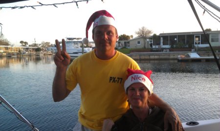 Naughty And Nice (New Port Richey, FL), a newly married couple wearing santa hats with Naughty and Nice written on them.