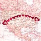 Heart stickers showing distance on a map.