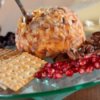 Cheese ball on plate with crackers and berries