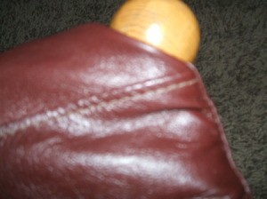 Leather Jacket Footstool - Turning and fitting the leather around the top of the legs.