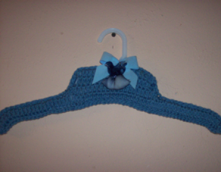 Blue crocheted clothes hanger.