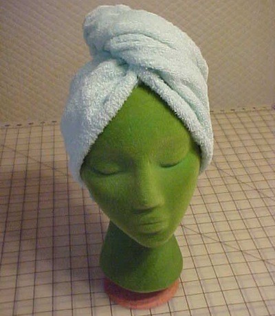 A turban towel on a green mannequin head