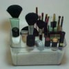 Makeup brushes and tubes arranged in a container.