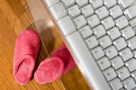 Slippers under a computer keyboard.