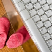 Slippers under a computer keyboard.