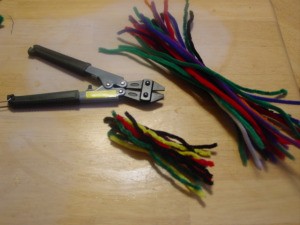 Pipe Cleaner Play Case - Cutting pipe cleaners into two lengths.