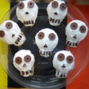 A plate of skull cupcakes.