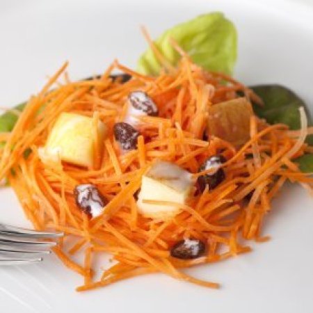 Carrot salad with cheese and raisens on lettuce