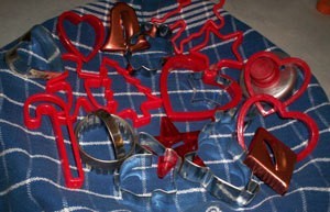 Variety of plastic and metal cookie cutters.