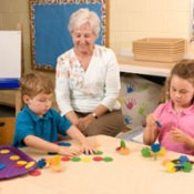 A grandma teach two younger children.