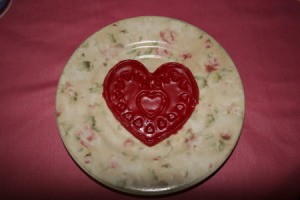 Recycled Candle Wax Air Freshener - Heart shaped wax freshener cooling on a plate.