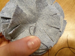 Sewing down through top of stack of circles.