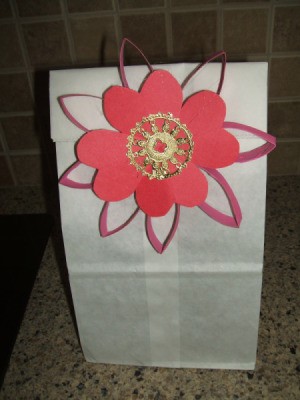 Flower attached to gift bag.