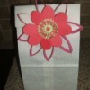 Flower attached to gift bag.
