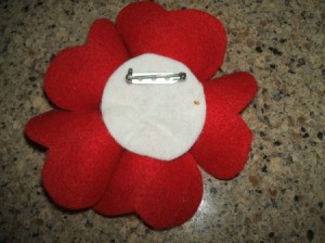 Pin back on heart petal flower.