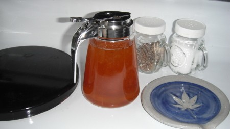 Honey being stored in a syrup dispenser.