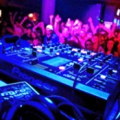 An electronic music festival showing a DJ's mixing board.