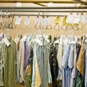 Row of clothes hung up at a dry cleaners.