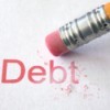 A pencil eraser that is erasing the word "Debt"
