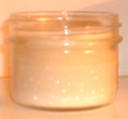 A jelly jar with a candle poured into it.