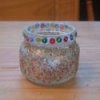 Candle holder made from a baby food jar and covered with glitter
