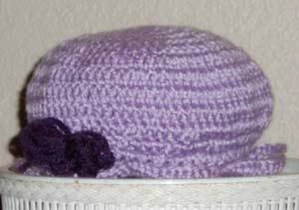 A purple crocheted hat for a toddler.