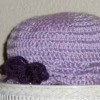 A purple crocheted hat for a toddler.