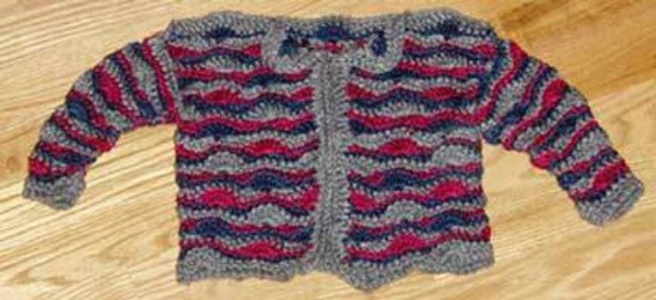 A striped crocheted baby sweater.