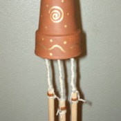 Wind chimes that are made from a clay pot.