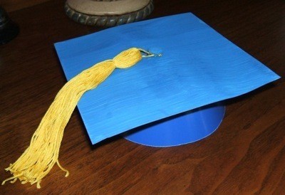 A homemade blue graduation cap with a golden tassle.