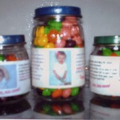 Baby food jars filled with candy as a favor.