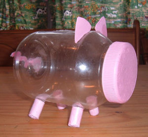 A pink piggy bank made from a plastic mayo bottle.