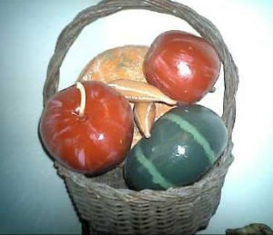 A basket with brightly painted gourds.