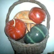 A basket with brightly painted gourds.
