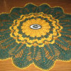 A doily in yellow and green with a G for Green Bay Packers.
