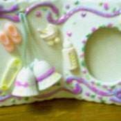 A frame for a baby girl decorated with glitter.