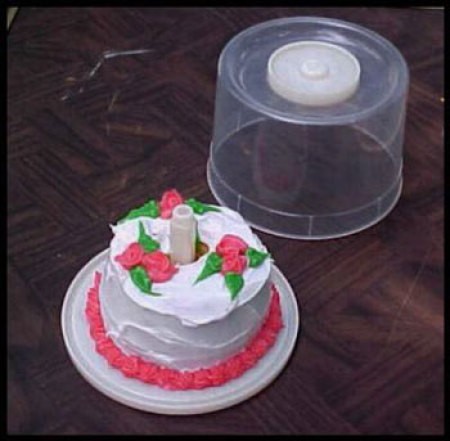 A birthday cake for just one, served in a recycled CD spindle.