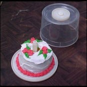 A birthday cake for just one, served in a recycled CD spindle.
