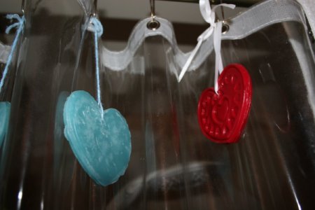 Recycled Candle Wax Air Freshener - Air fresheners hanging from shower curtain rings.