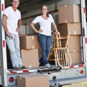 A couple loading a moving truck.