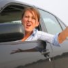 Photo of a lady yelling at a driver.