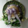 Straw hat decorated with flowers and greenery.